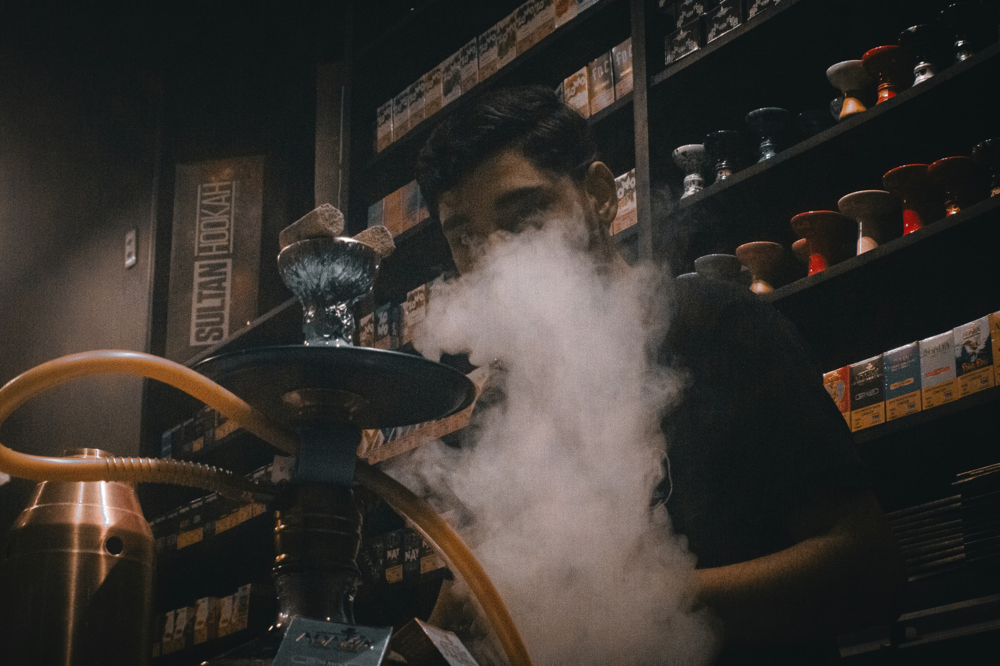 Shisha lounge interior, low light, hookahs in the foreground